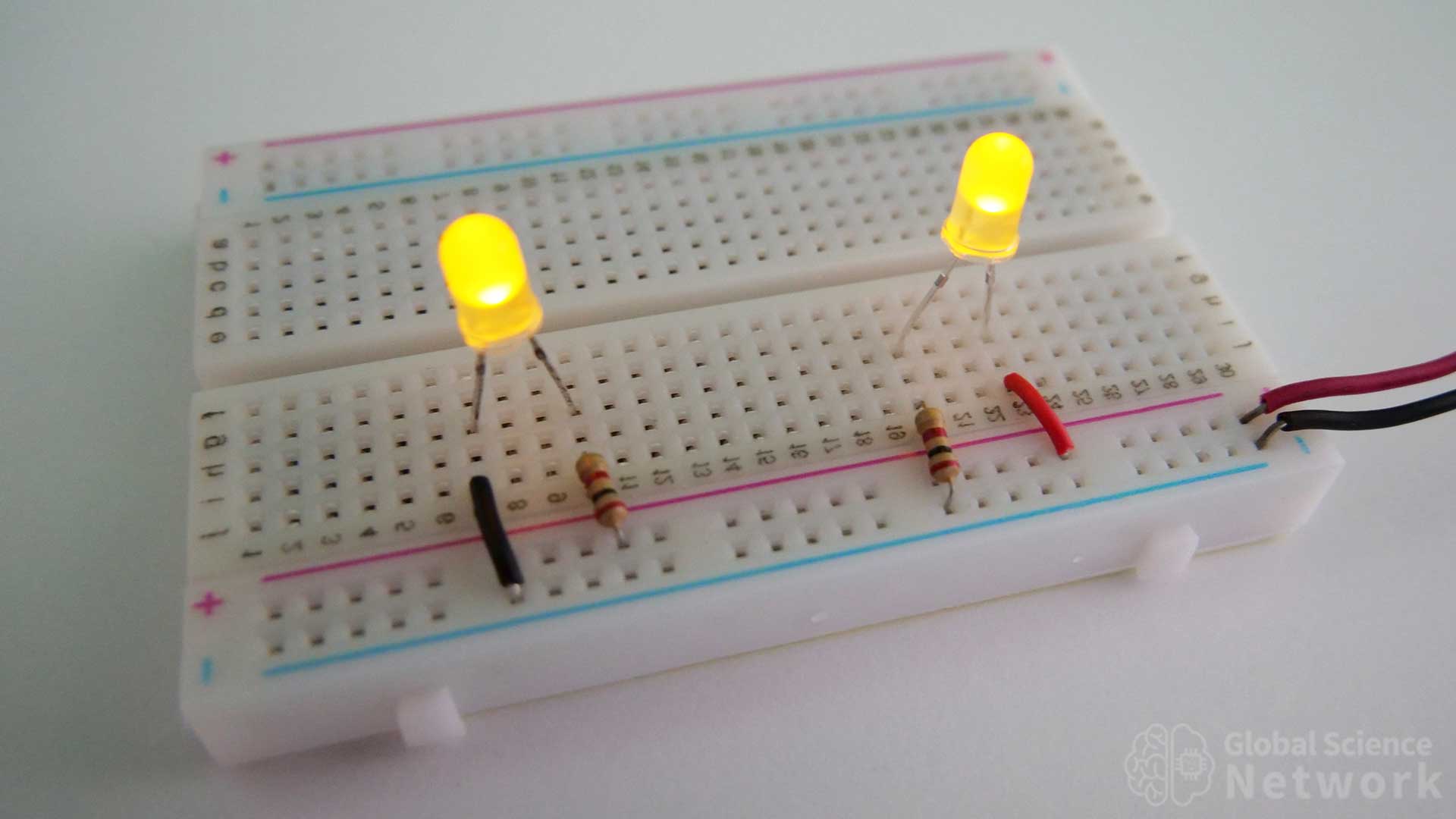 LED with a resistor on the positive terminal and LED with a resistor on the ground terminal