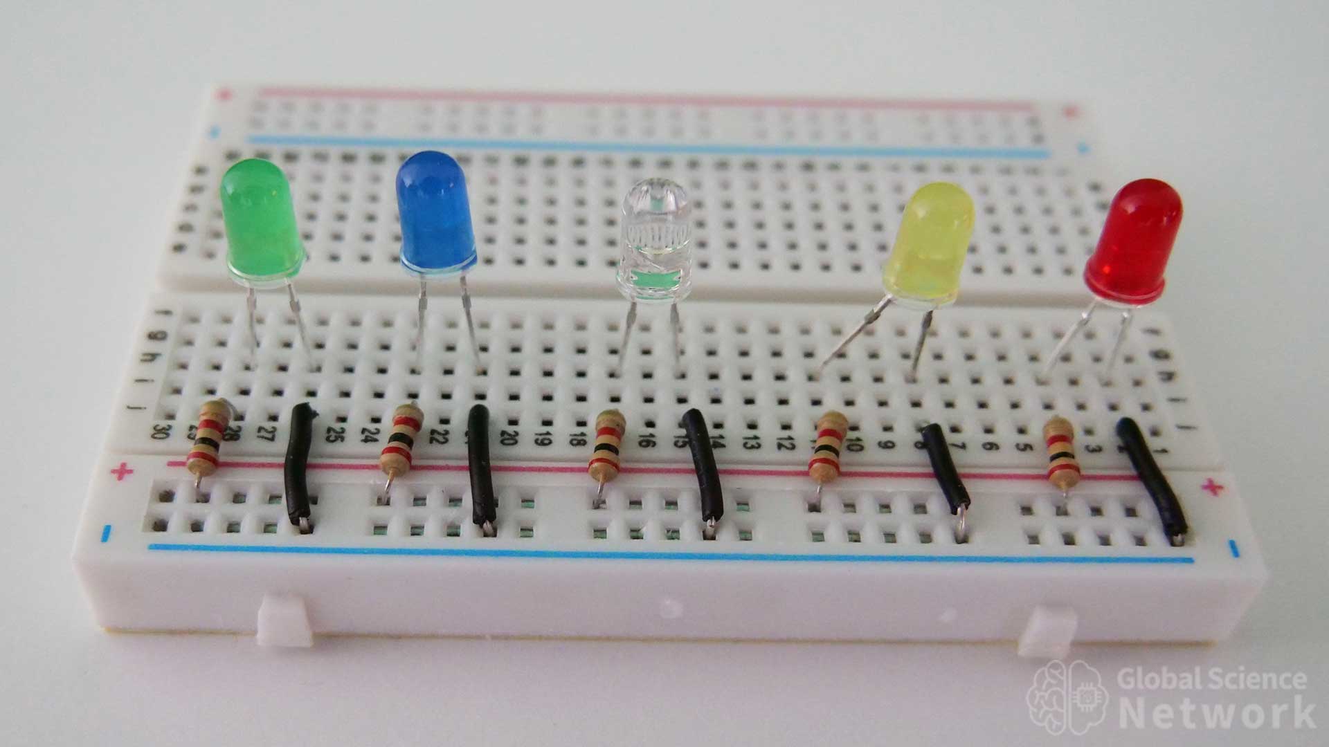 green blue white yellow and red LED on a breadboard with current limiting resistors